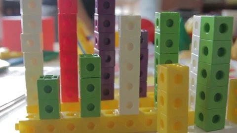 Teachers displaying toys at the table Stock Footage 87630871