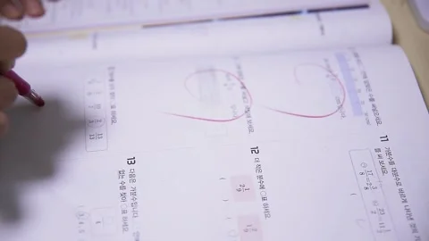 Teacher's Hand Scoring a Child's Test Paper Stock Footage 292913400