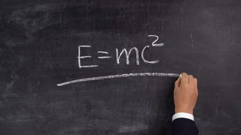 The teacher's hand writes the formula E=mc2 on the blackboard Stock Footage 164134910