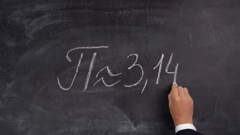 The teacher's hand writes the number Pi = 3.14 on the blackboard Stock Footage 164134897
