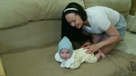 Teaching Baby to roll over from back to belly. Stock Footage 335243324