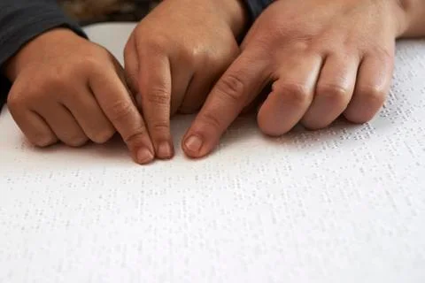 Teaching blid kid to read text in braille language Stock Photos