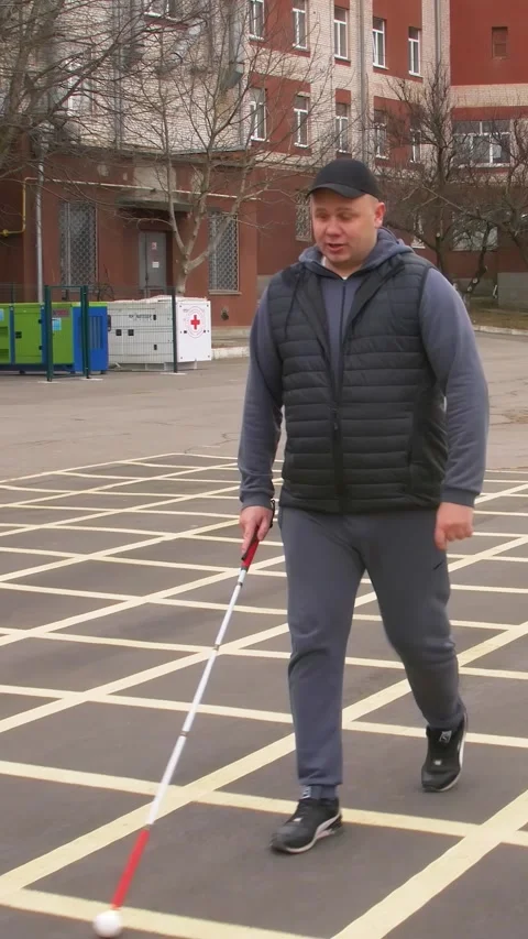 Teaching the blind to walk with a cane. Vertical video. Stock Footage 303416083