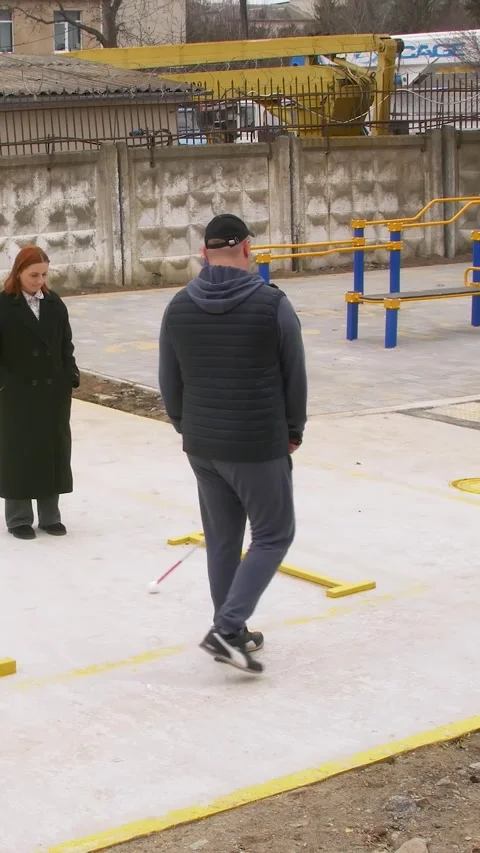 Teaching the blind to walk with a cane. Vertical video. Stock Footage 303416085