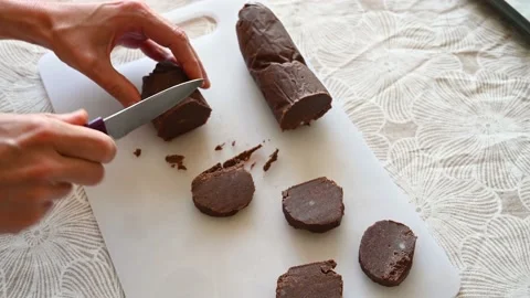 Teaching to cut a fresh cookie roll Stock Footage 220834118