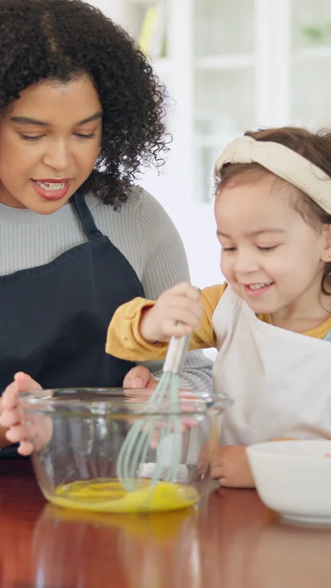 Teaching, egg and kid baking with mom in kitchen for recipe preparation in Stock-Footage 335372596
