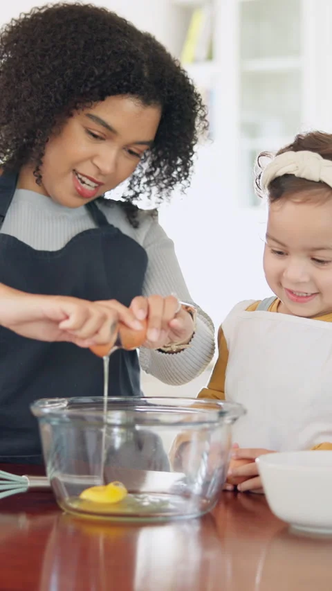 Teaching, egg and kid baking with mother in kitchen for recipe preparation in Stock-Footage 335387470