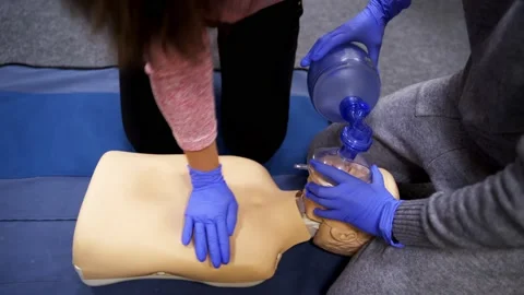 Teaching first aid CPR techniques Stock Footage 143426724