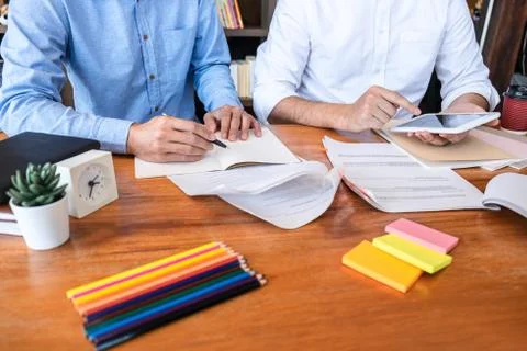 Teaching helping and study course, Team of young teacher or tutor helps stude Stock Photos