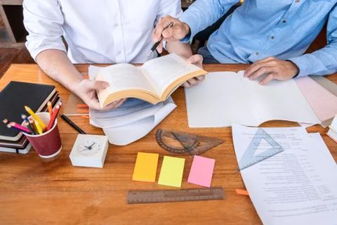 Teaching helping and study course, Team of young teacher or tutor helps stude Stock Photos