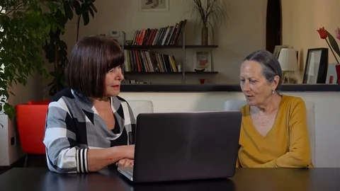 Teaching how to use a personal computer: old women using laptop computer Stock Footage 84238751