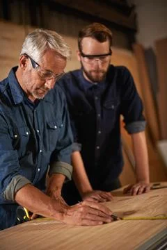 Teaching, learning and carpentry apprentice with measuring tape in designer Stock Photos
