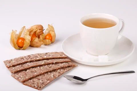 Teacup with rye grain bread and physalis Stock Photos