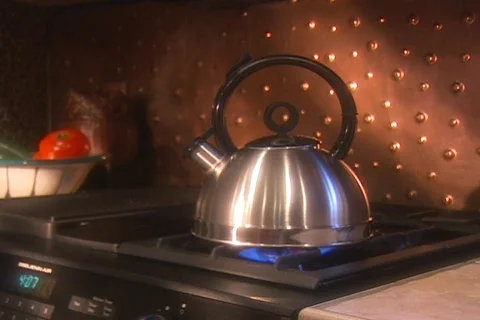 Teak kettle on stove Stock Footage 753271
