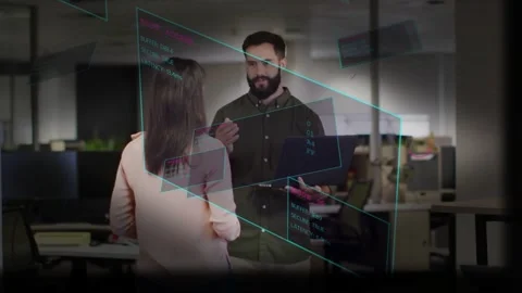 Teal AR panels appearing, developer holding laptop gesturing to explain code Stock Footage 333904925