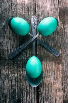 Teal easter eggs with spoons Stock Photos