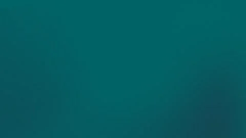 Teal gradient seamless loop background in 4K resolution with subtle grain. Stock Footage 300840158