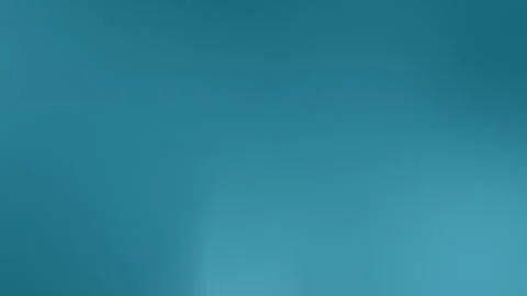 Teal grainy seamless loop background. Smooth gradient texture in 4K. 動画素材 309700899