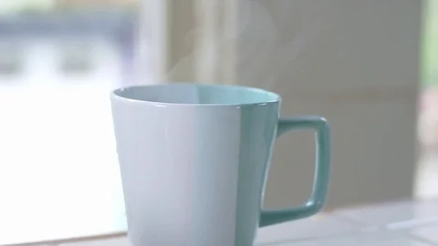 Teal mug filled with steaming hot water Stock Footage 84473266
