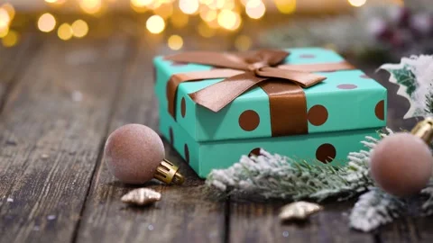 Teal Polka Dot Gift Box with Brown Ribbon on Rustic Wood Stock Footage 345561683