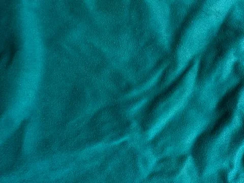 Teal silk fabric texture with soft folds and shiny surface, luxury textile .. Stock Photos