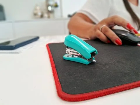 Teal stapler on table Stock Photos