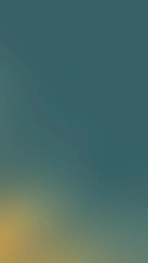 Teal to yellow gradient with soft grain texture. Seamless loop background. 4K Stock Footage 309855859