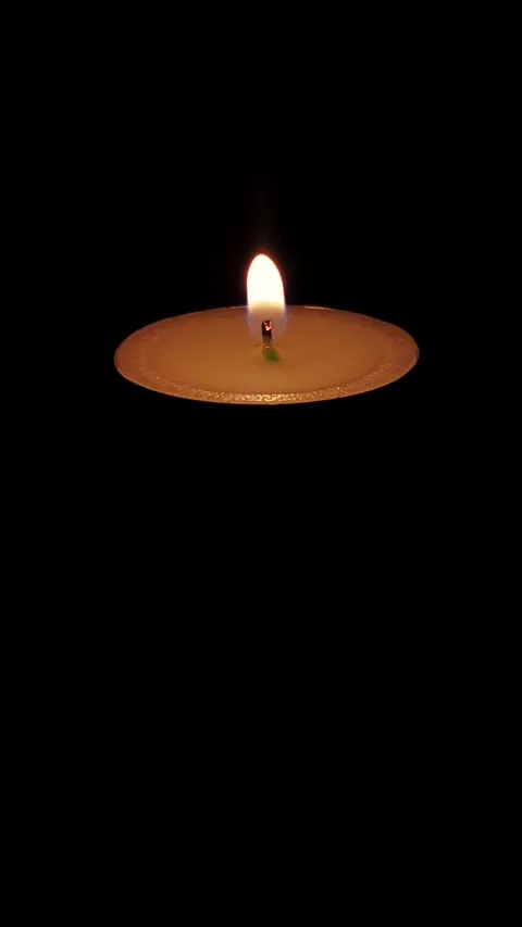 Tealight Candle Flame Flickering in Dark Vertical Frame Stock Footage 345272492