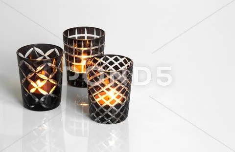 Tealights in black and white candleholders Stock Photos