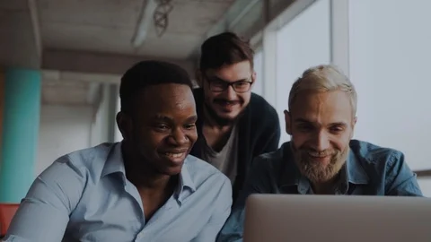 Team of 3 young professional working in the office in front of the computer. Stock Footage 99186942