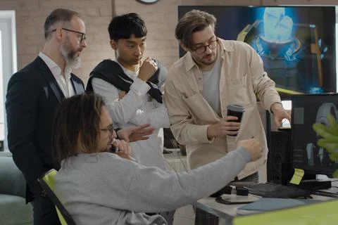 A team of 3D game and application developers discuss the project in the studi Stock Photos