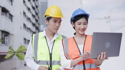 Team of active Asian civil engineers use laptop computer to inspect building Stock Footage 158811638