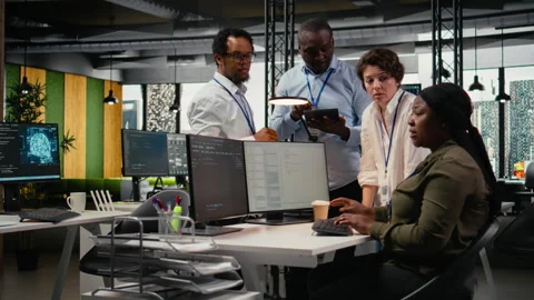 Team of admins brainstorm in AI startup office to train predictive models Stock Footage 323409546