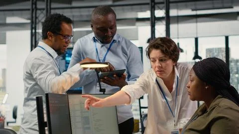Team of admins brainstorm in AI startup office to train predictive models Stock Photos