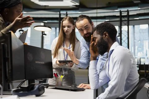 Team of admins collaborate to block hacking network intrusion Stock Photos