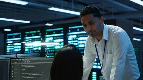 Team of admins in data center ensuring system can handle networking tasks Photos