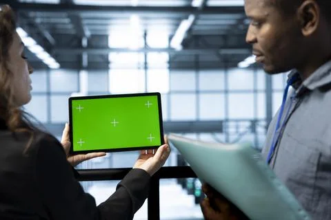 Team of admins in data center using chroma key green screen tablet Foto stock