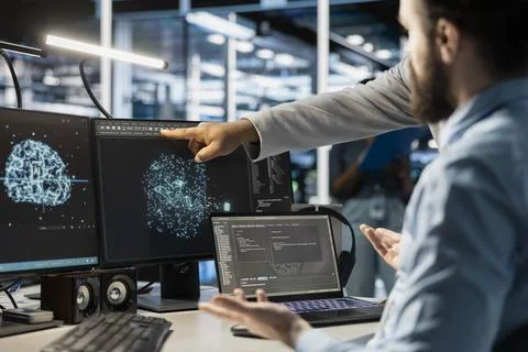 Team of admins using computer in data center, integrating AI automation tools Stock Photos