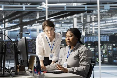 Team of admins working together in server hub, analyzing rigs data 스톡 사진