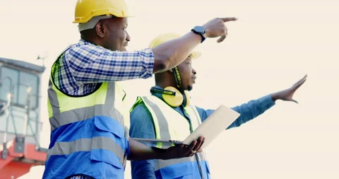 Team of African-American container workers use their laptops to inspect shipping Видео 200859649