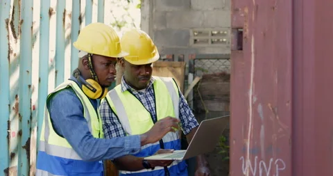 Team of African-American container workers use their laptops to inspect shipping Stock-Footage 200859743
