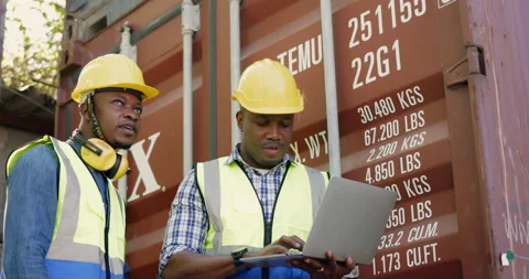 Team of African-American container workers use their laptops to inspect shipping Vídeo Stock 200859890