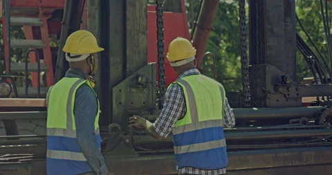 Team of African-American container workers use their laptops to inspect shipping Stock Footage 203838881