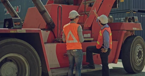 Team of African-American container workers use their laptops to inspect shipping Stock Footage 203839428