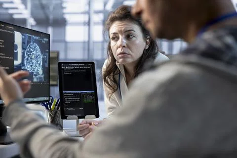 Team of AI technicians using PC to check for system failures Stock Photos