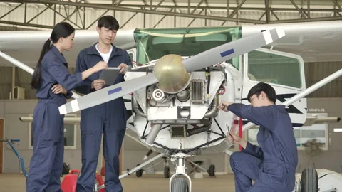 Team of aircraft maintenance engineer doing a checkup in hangar. Stock Footage 141992404