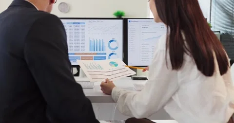 Team of analysts reviewing data dashboards and finance charts on computer Stock Footage 341704673