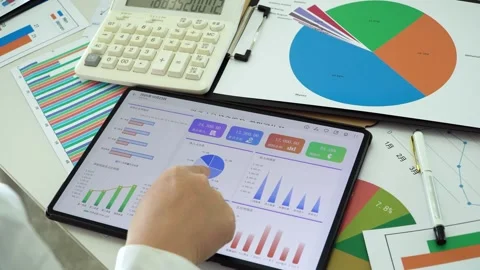 The team analyzed financial statements and calculated operating data. Stock Footage 328398132