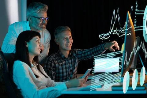 Team Analyzing Data on Digital Display in a Modern Office Stock Photos