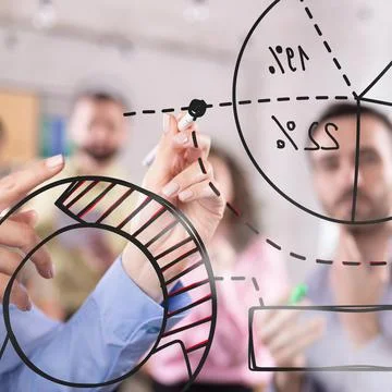Team analyzing data-driven insights, visually mapping financial trends with pie Stock Photos